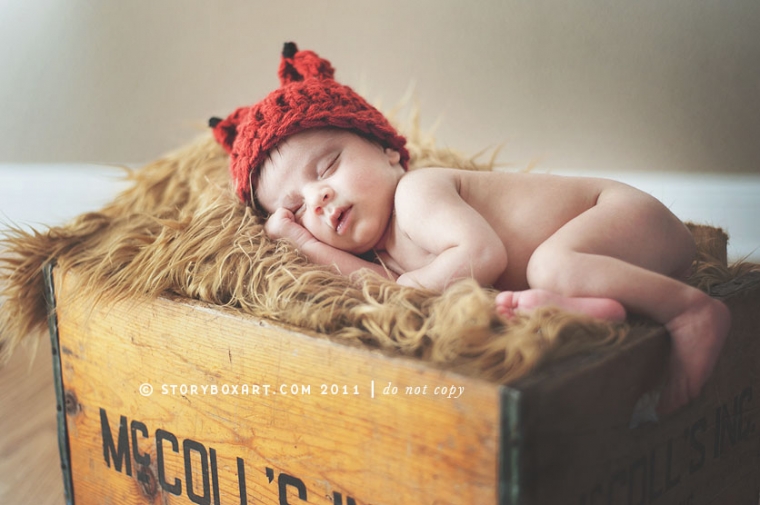 Newborn sleeping baby in a wooden box